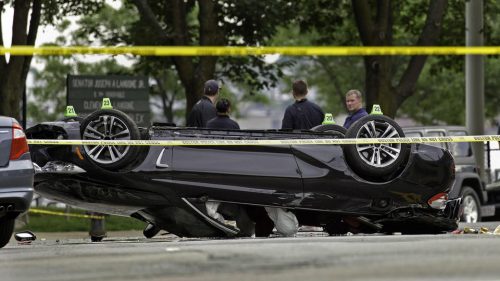 06/12/15-Boston,MA. A car is seen flipped on its roof shortly after sunrise Friday on Causeway St. in the North End. The car hit a parked car and flipped. Unconfirmed media reports state 2 are dead.. Staff photo by Mark Garfinkel